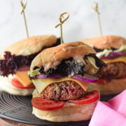 a plate of veggie burgers with toppings on them