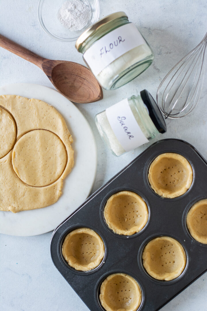 cookie cups in tin pricked with fork