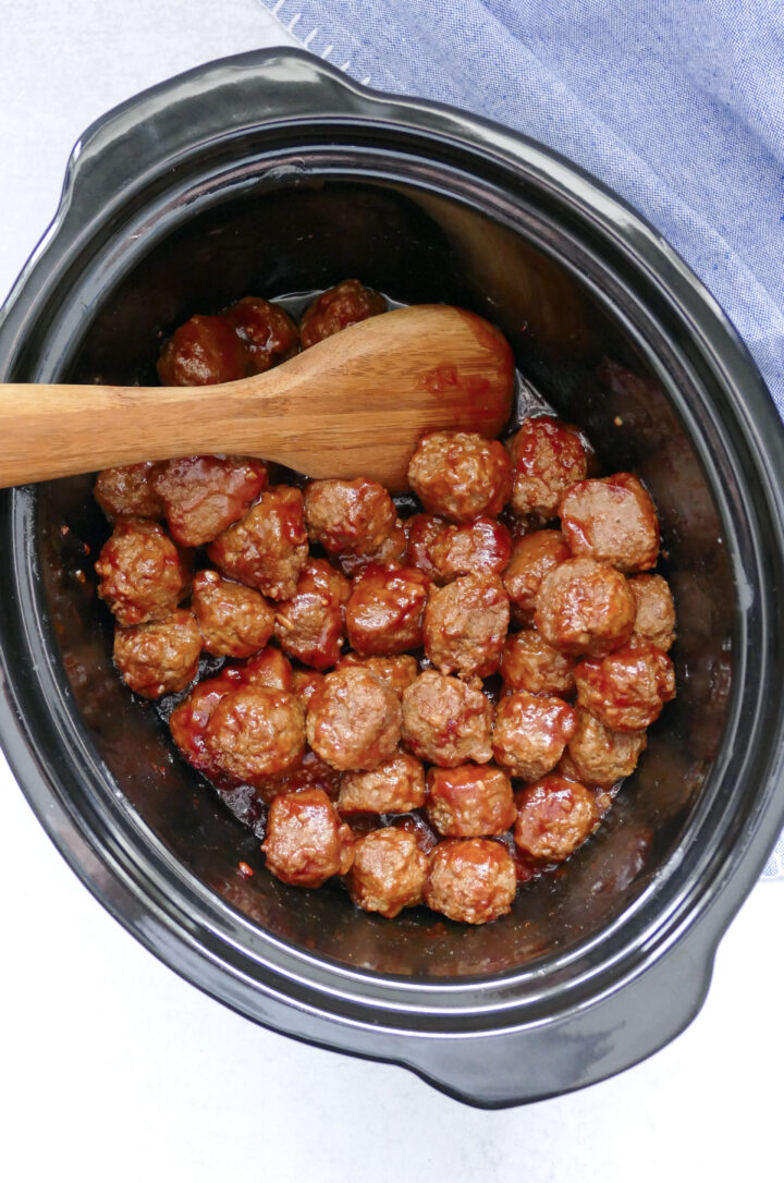 Crockpot full of sweet and spicy meatballs ready to be spooned up.