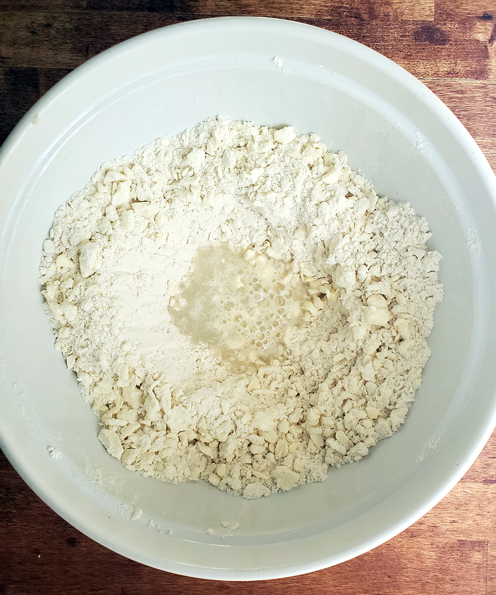 adding ice water to puff pastry dough